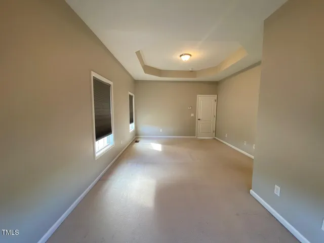 an empty room with windows and entrance