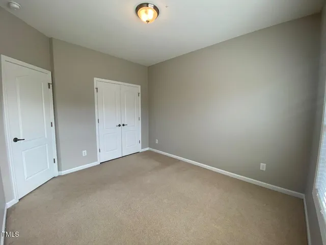 an empty room with white wall