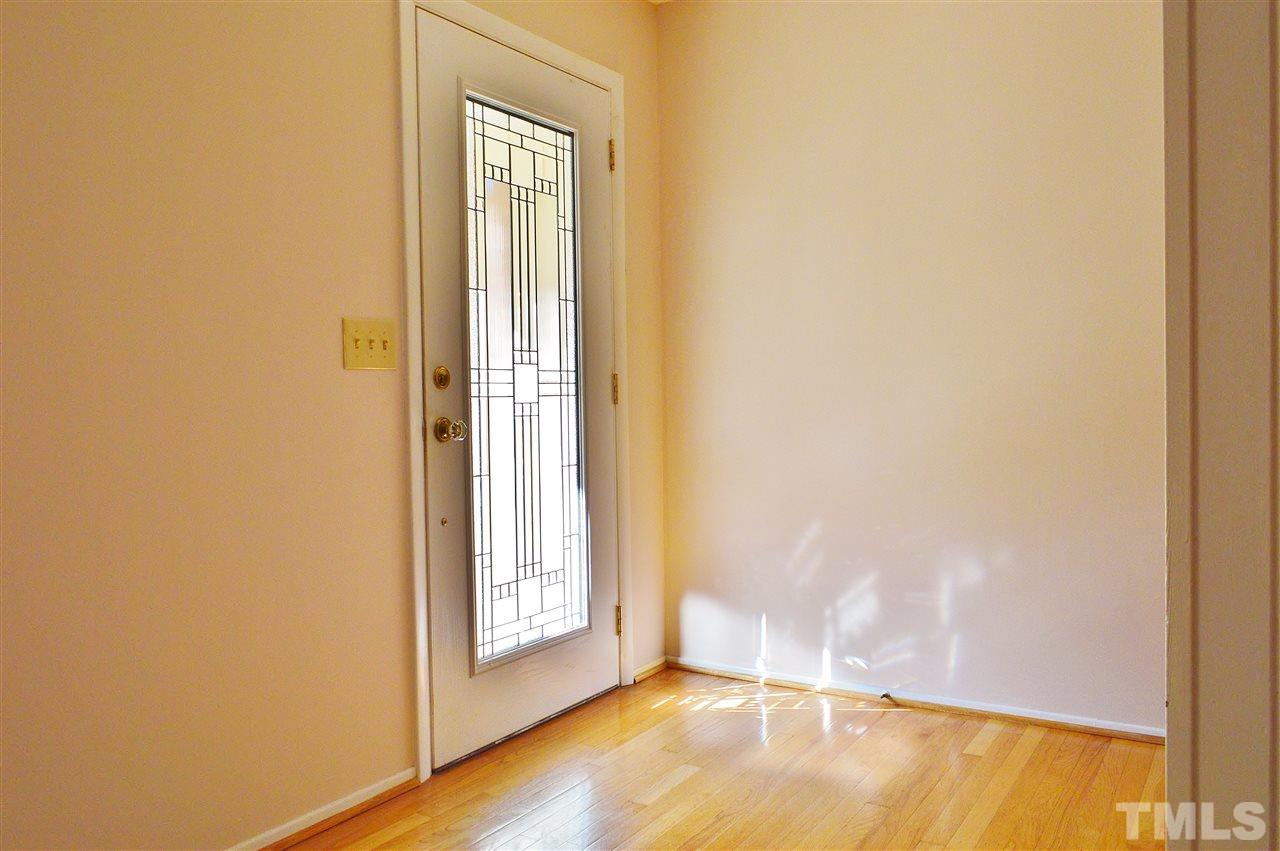 3104 Chancery Place Raleigh, NC 27607 - Photo 4 of 25 Foyer has hardwood floors and a leaded-glass front door.