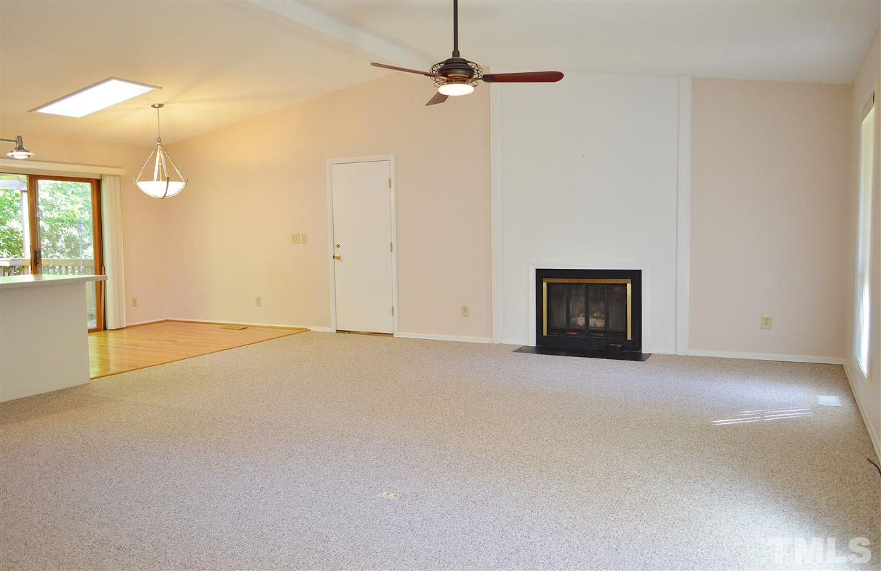 3104 Chancery Place Raleigh, NC 27607 - Photo 5 of 25 The living room has a cathedral ceiling and is open to the kitchen and dining areas. It has fresh paint and new carpet. The fireplace has gas logs. The