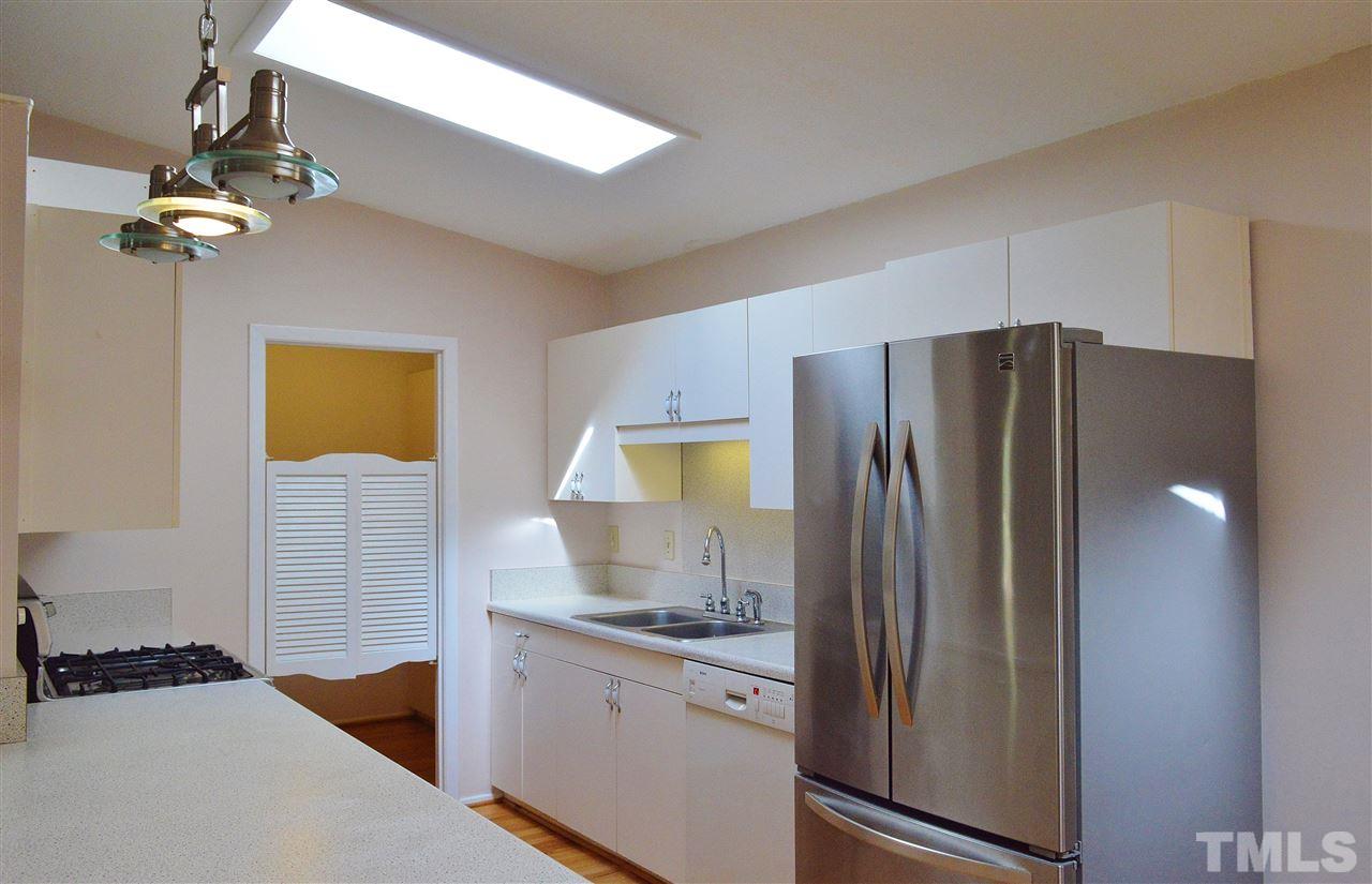 3104 Chancery Place Raleigh, NC 27607 - Photo 7 of 25 The kitchen has a vaulted ceiling with skylight and hardwood floors.