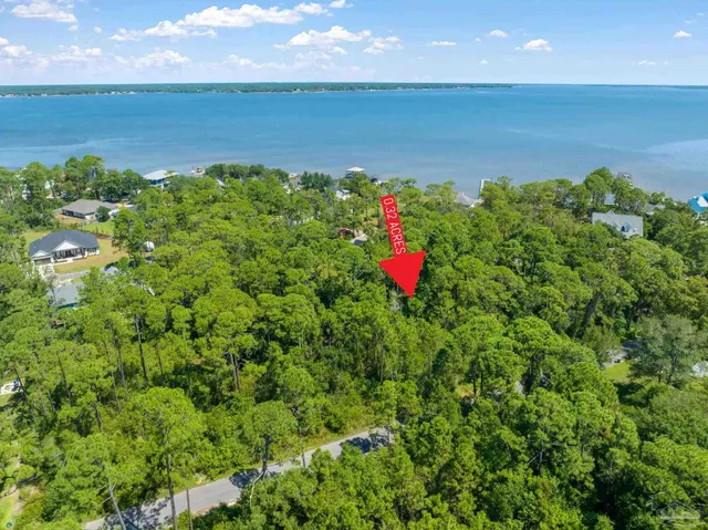a view of a large body of water with a building in the background