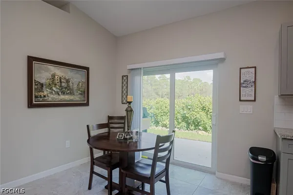 a dining room with furniture and window