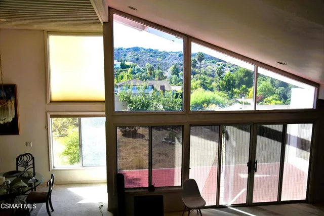 a view of a room with balcony and furniture