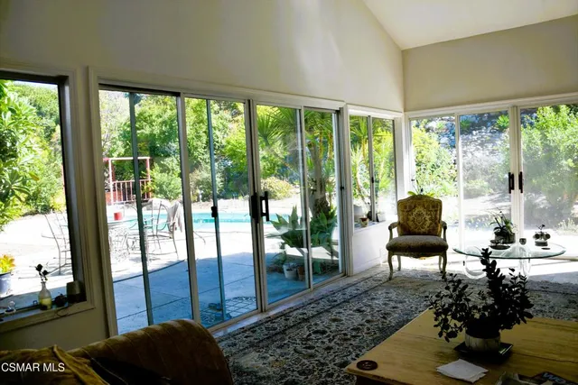 a living room with furniture and a floor to ceiling window