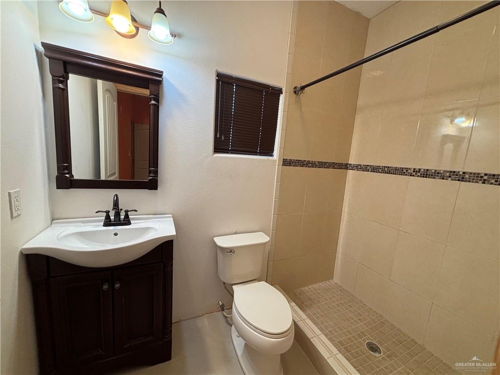 45 Zinnia Street Rio Grande City, TX 78582 - Photo 15 of 31 a bathroom with a sink vanity mirror and toilet