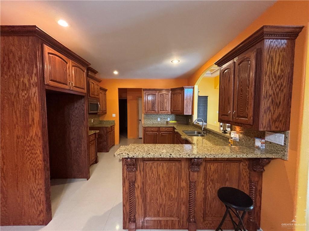 45 Zinnia Street Rio Grande City, TX 78582 - Photo 5 of 31 a kitchen with stainless steel appliances granite countertop a sink refrigerator and cabinets