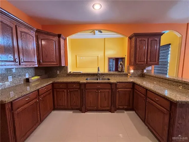 a large kitchen with a large window and a sink