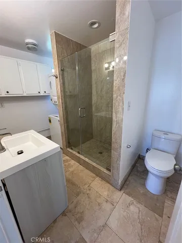 a bathroom with a shower a toilet and a sink