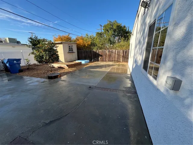 a view of a patio with table and chairs and potted plants