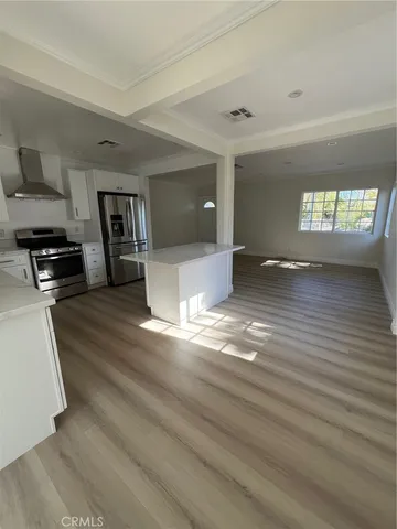 a view of a kitchen and an empty room