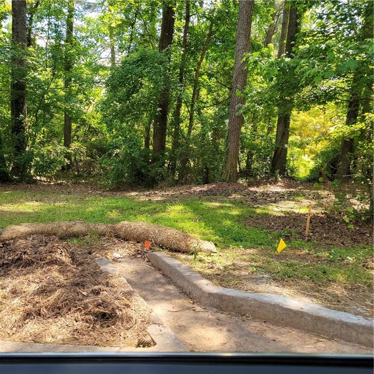 0 Cemetery Street Fairburn, GA 30213 - Photo 1 of 1 a backyard of a house with a yard and outdoor seating