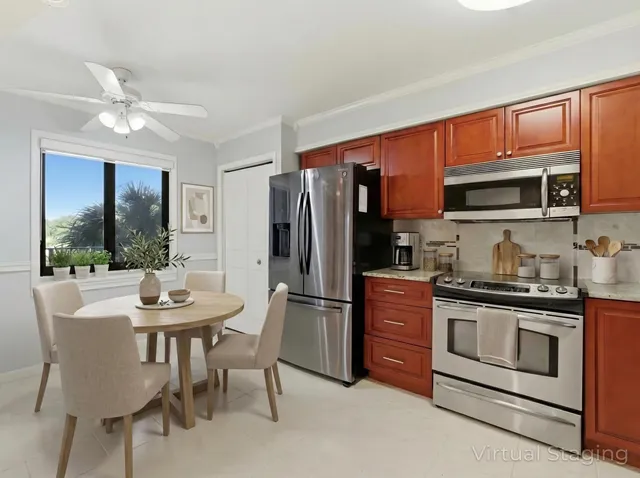 a kitchen with stainless steel appliances granite countertop a refrigerator oven a sink dishwasher and a refrigerator with wooden cabinets