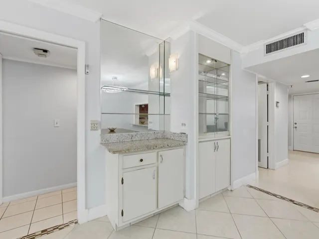 a living room with furniture and paintings on the wall