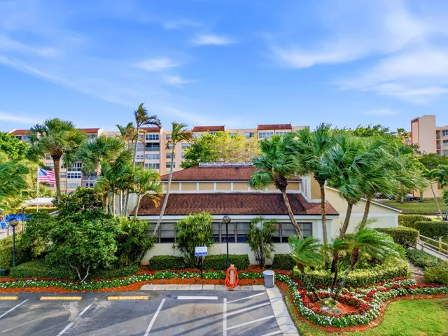 a living room with furniture a fireplace and a chandelier