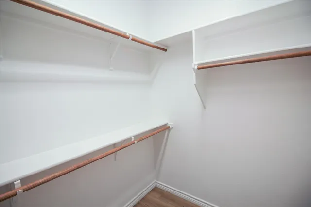 a bathroom with a granite countertop sink a mirror and a shower