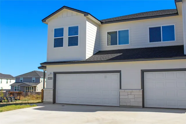 a front view of a house with parking
