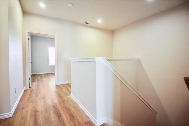 a view of hallway with wooden floor