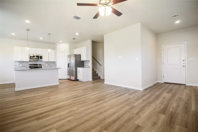a view of a kitchen with a sink and stainless steel appliances