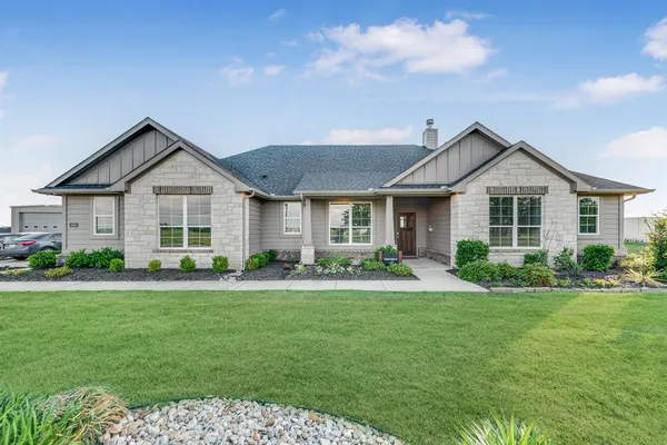 a front view of a house with a yard and porch