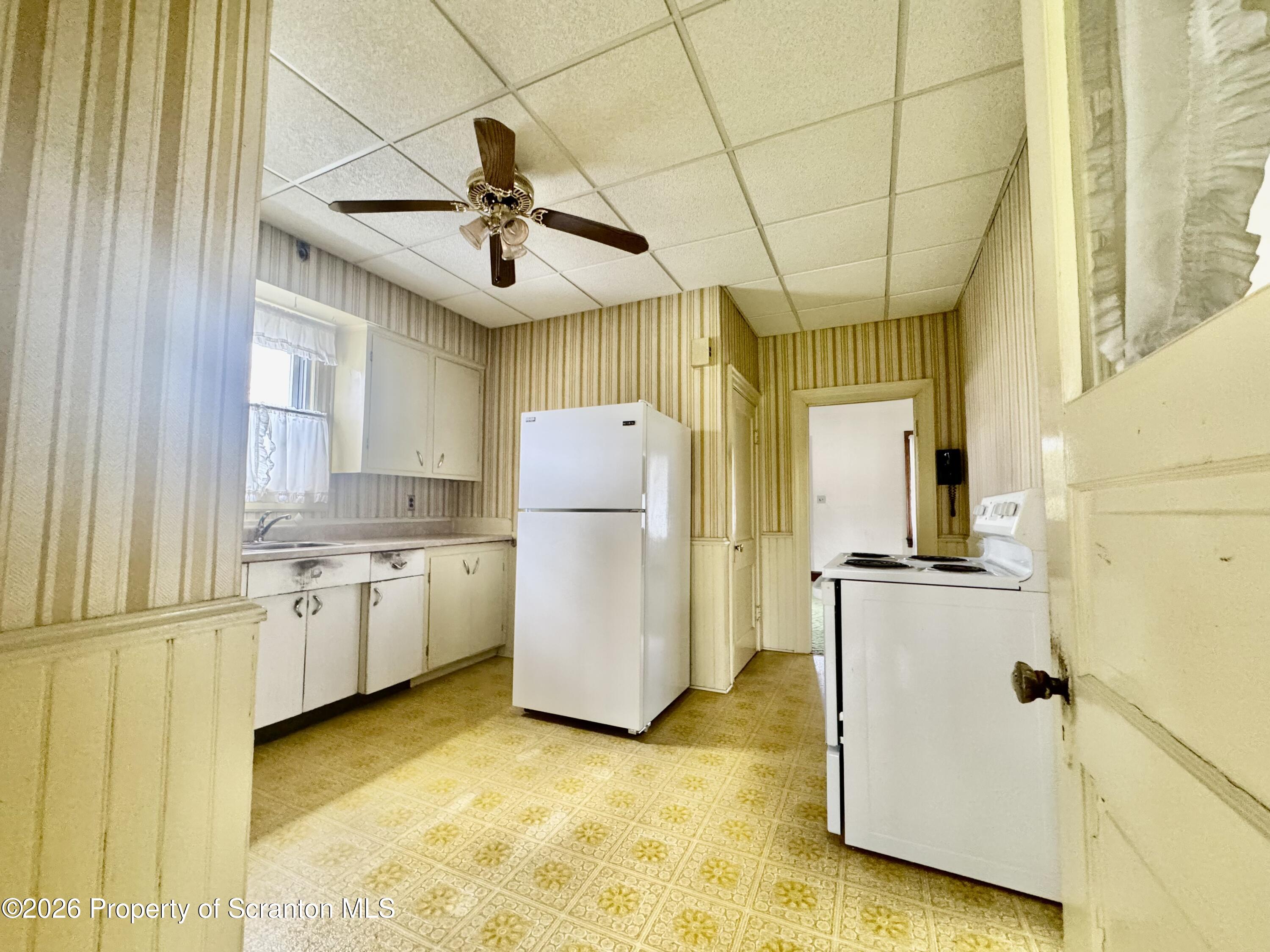2120 Myrtle Street Scranton, PA 18510 - Photo 25 of 42 a view of a kitchen with refrigerator and windows