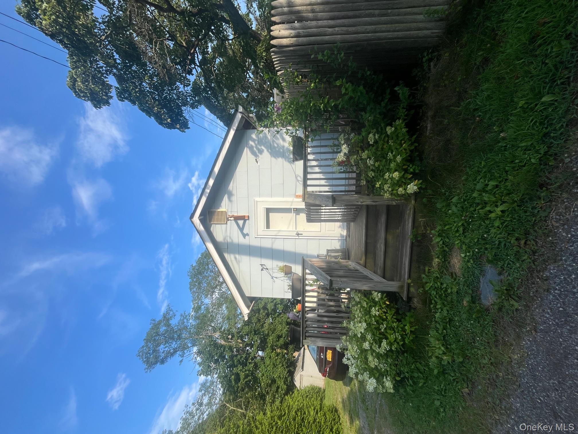 560 Pacific Street Mattituck, NY 11952 - Photo 7 of 7 a view of a house with yard and plants