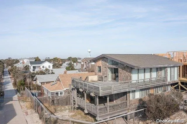 an aerial view of residential houses with wooden fence