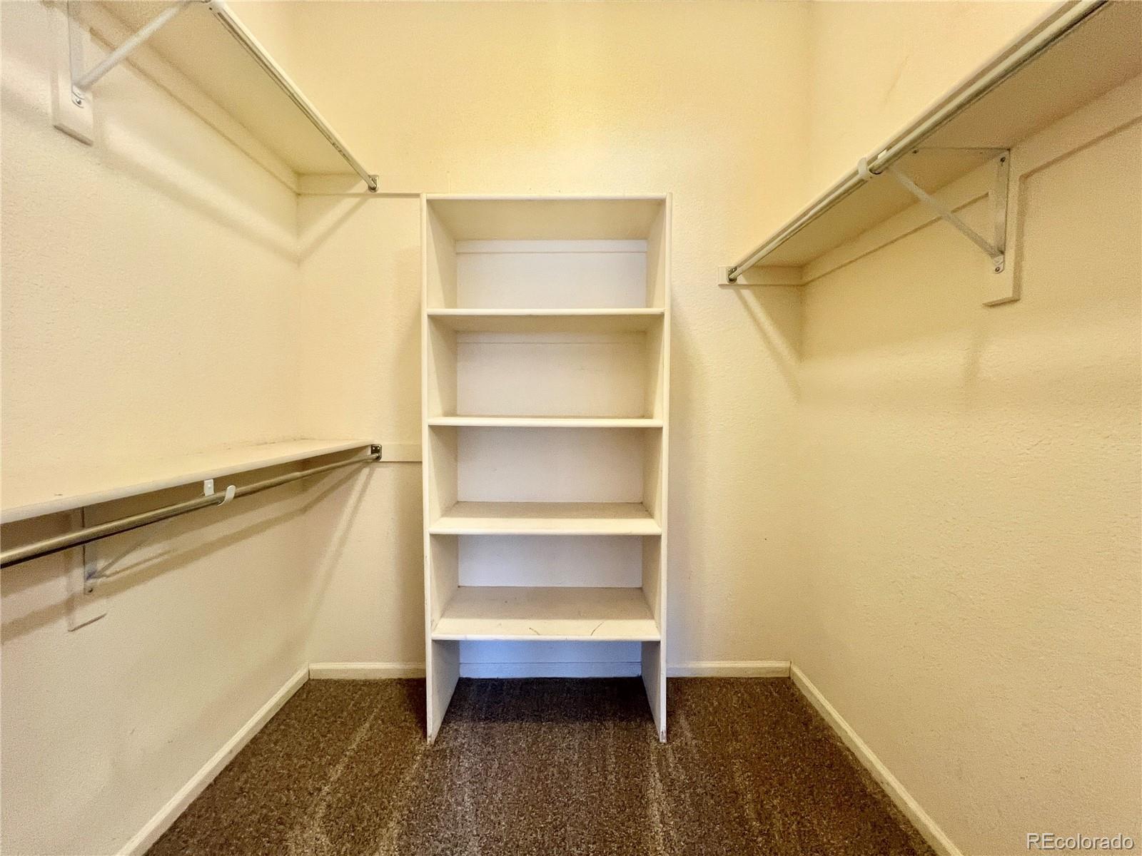1385 South Chambers Road, Unit 102 Aurora, CO 80017 - Photo 10 of 20 a view of walk in closet with empty racks