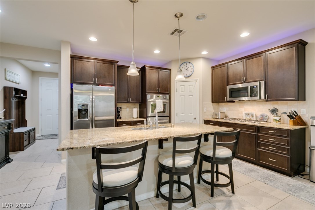 7375 Campbell Ranch Avenue Las Vegas, NV 89179 - Photo 10 of 45 Granite counters and stainless steel appliances complete this well-appointed kitchen.