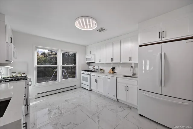 a kitchen with stainless steel appliances a refrigerator sink and cabinets