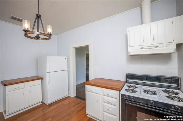 a kitchen with a stove and a refrigerator