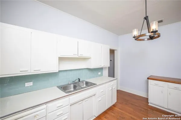 a kitchen with a sink and cabinets