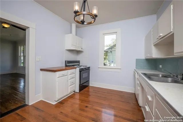 a kitchen with stainless steel appliances granite countertop a sink a stove a microwave and island