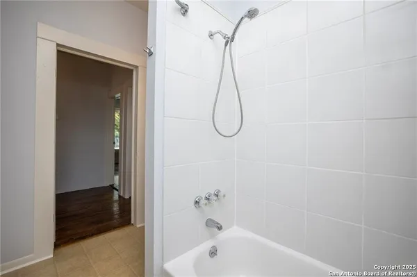 a bathroom with a bath tub and a shower