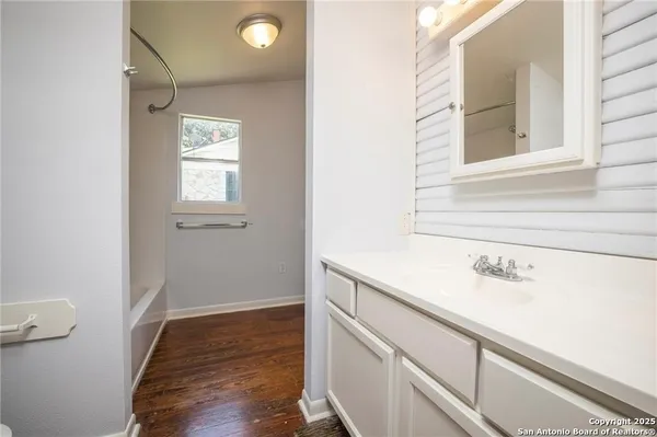 a view of a bathroom with a sink and a window