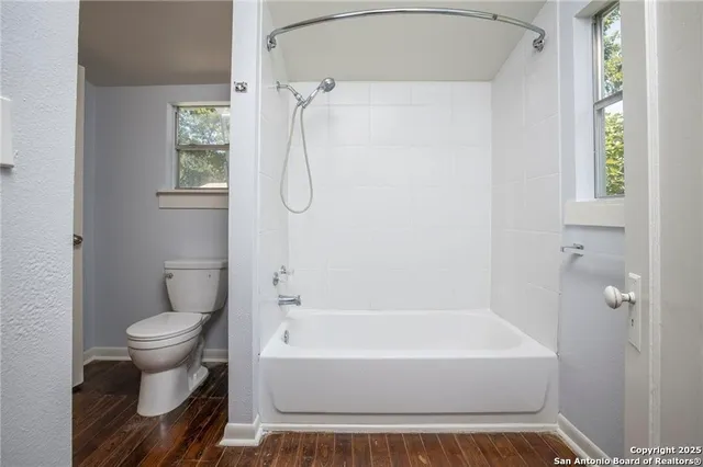 a bathroom with a toilet and a bathtub
