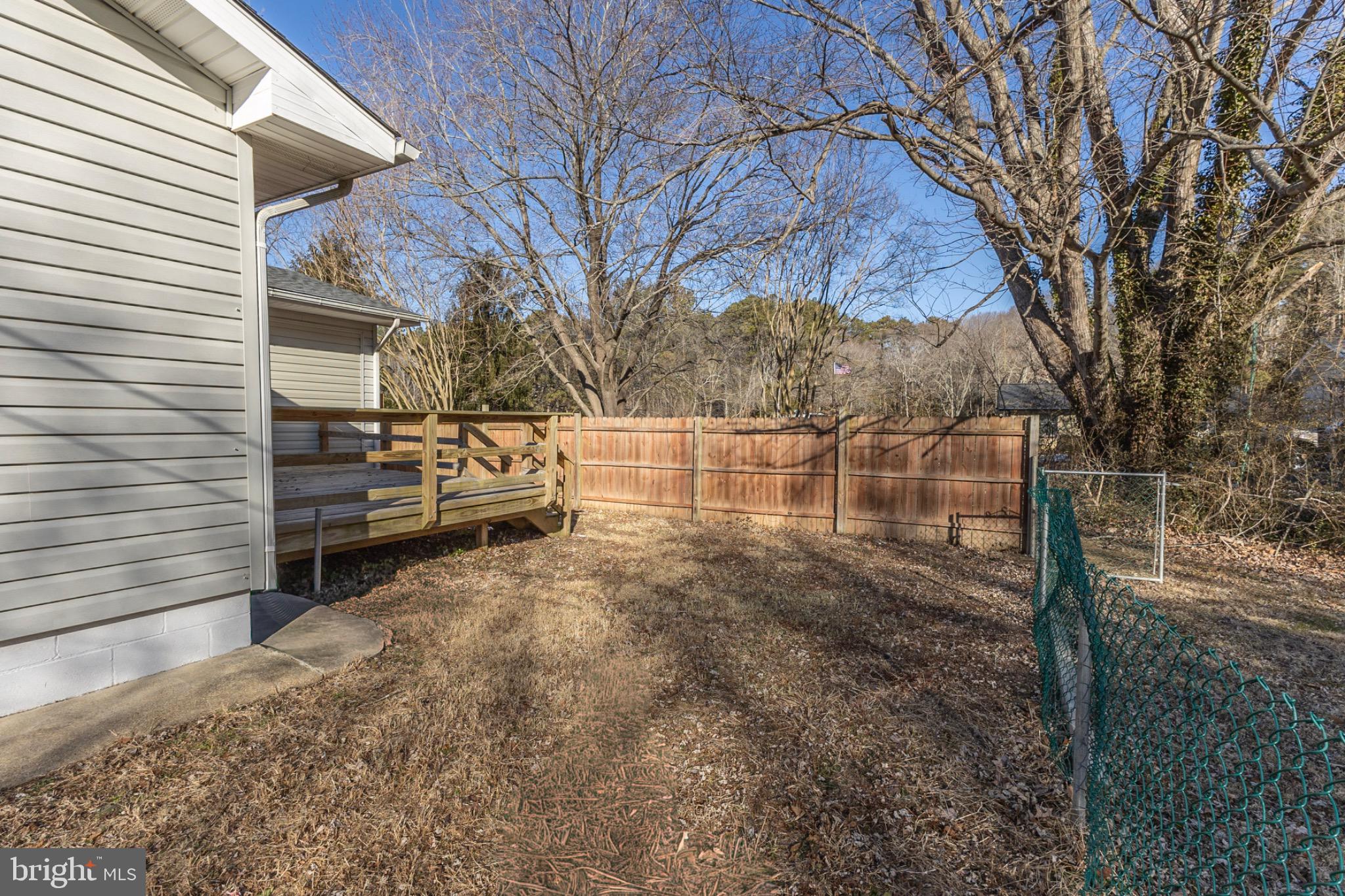 49151 Wynne Road Ridge, MD 20680 - Photo 68 of 80 Spacious backyard with wooden deck and fence.