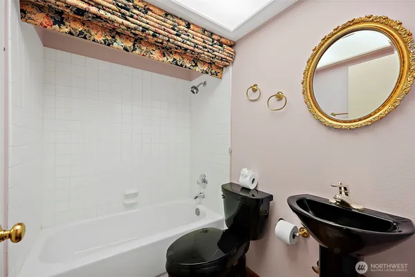 a bathroom with a sink a toilet and a mirror