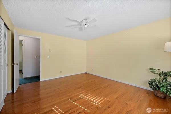 a view of a room with wooden floor and closet
