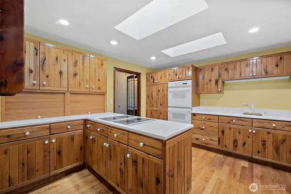 a kitchen with stainless steel appliances granite countertop a sink and dishwasher stove with wooden cabinets