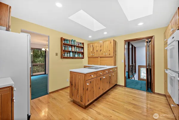 a kitchen with stainless steel appliances granite countertop a stove a refrigerator and a sink