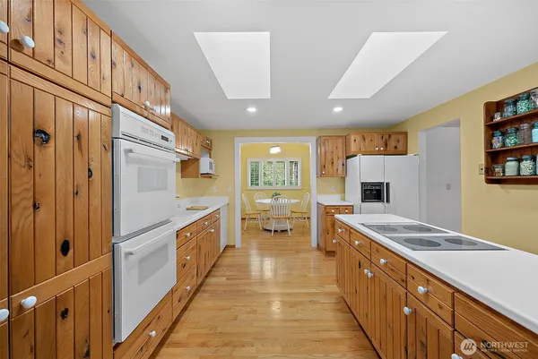 a large kitchen with stainless steel appliances granite countertop a refrigerator and a sink