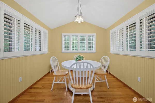 a view of a dining room with furniture window and wooden floor