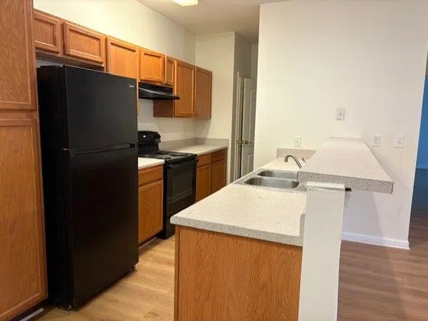a kitchen with a sink and a stove top oven