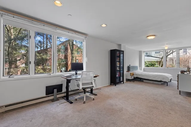 a view of a livingroom with workspace and a window