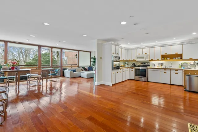 a view of a kitchen with dining room and wooden floor