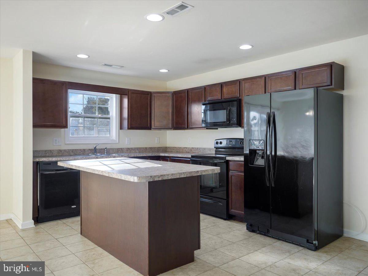 35 Montague Way Inwood, WV 25428 - Photo 2 of 38 a kitchen with a stove a refrigerator and a sink