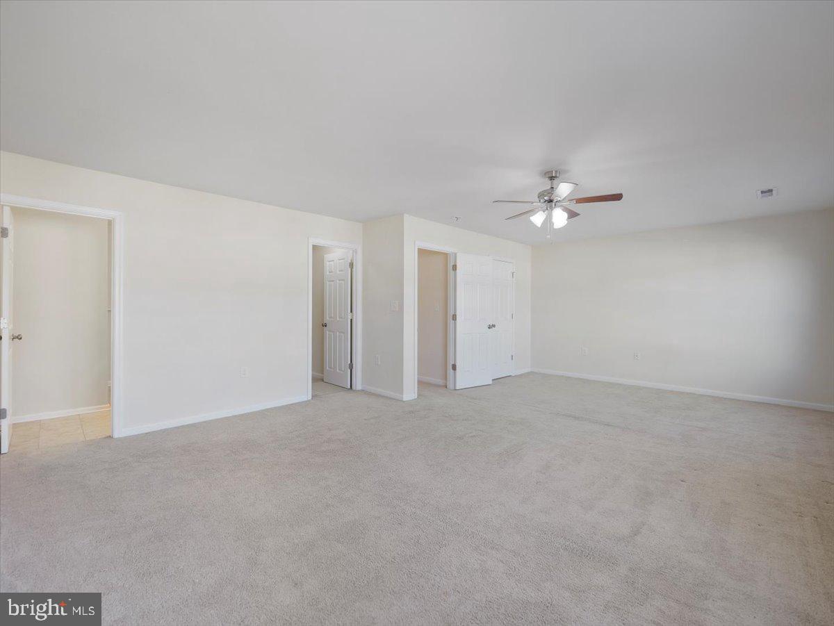 35 Montague Way Inwood, WV 25428 - Photo 27 of 38 a view of an empty room with a chandelier fan