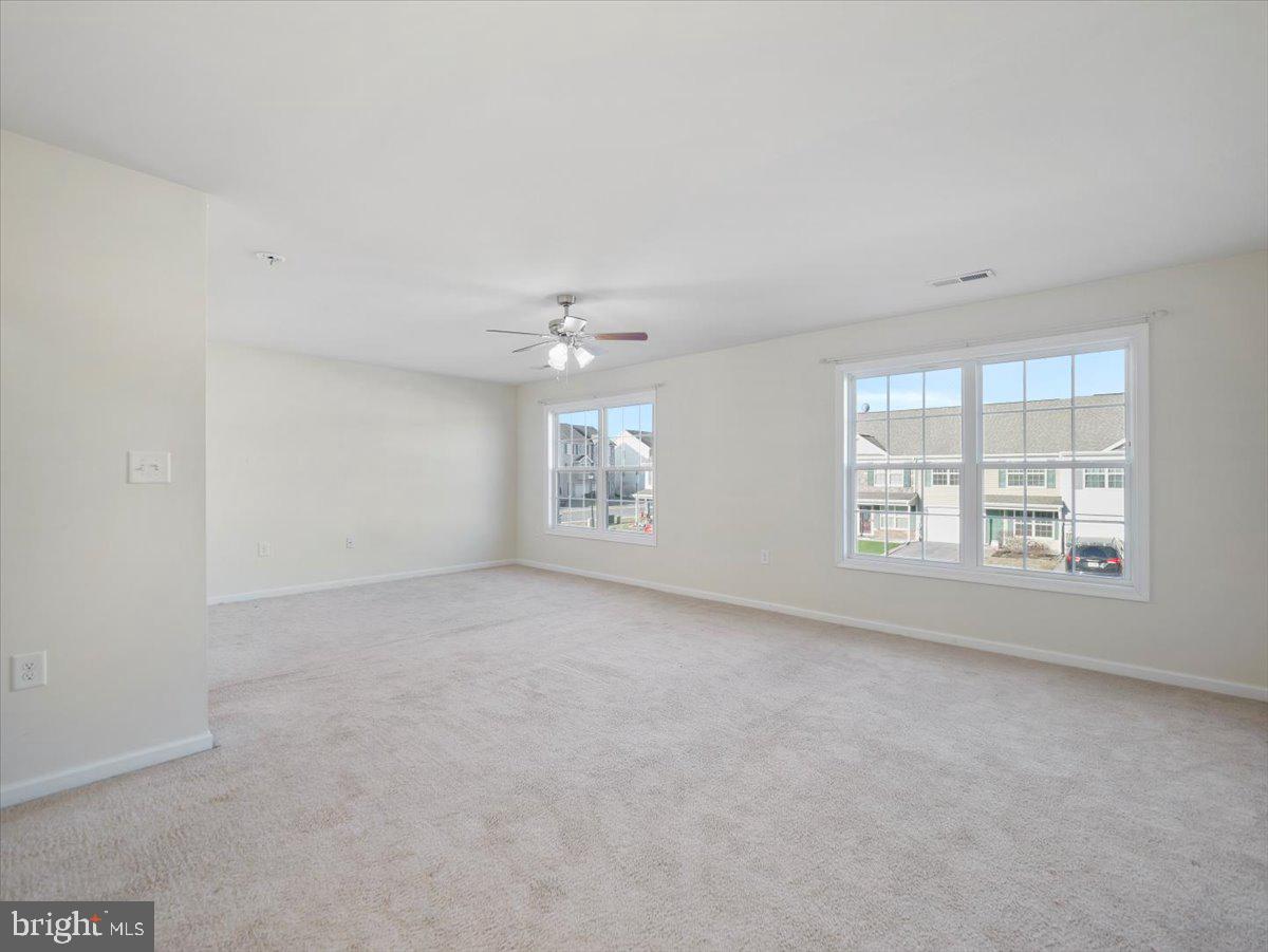 35 Montague Way Inwood, WV 25428 - Photo 29 of 38 an empty room with windows and chandelier fan