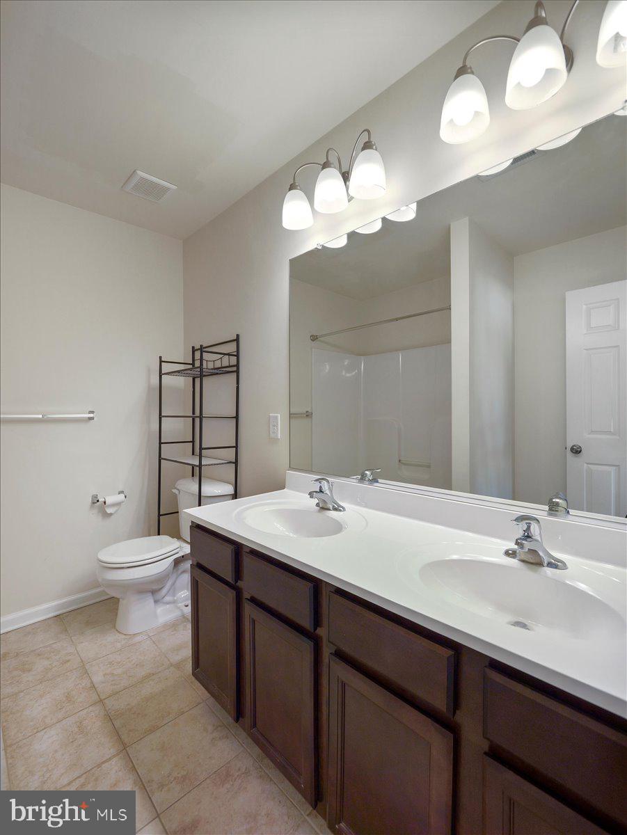 35 Montague Way Inwood, WV 25428 - Photo 30 of 38 a bathroom with a double vanity sink and a toilet